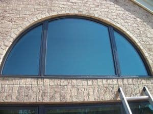 Close up of specialty shape window with black frame