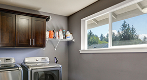 A laundry room featuring a large double window.