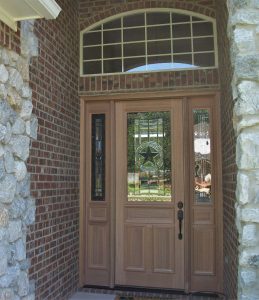 Wooden front door with site lites and transom window